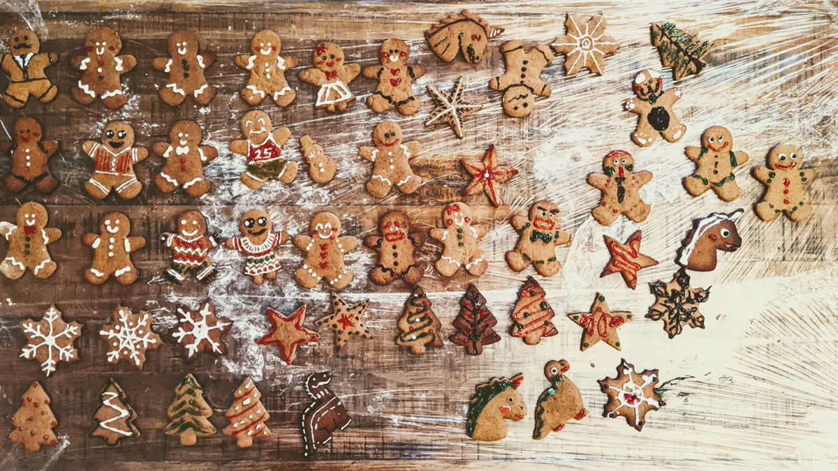 Freshly baked gingerbread holiday cookies decorated on a festive Christmas dessert table