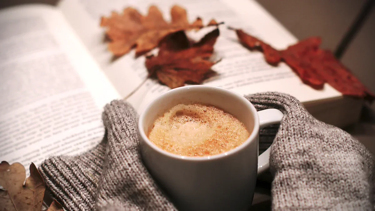 Stack of vintage books and warm seasonal decorations for comfortable autumn evening entertainment